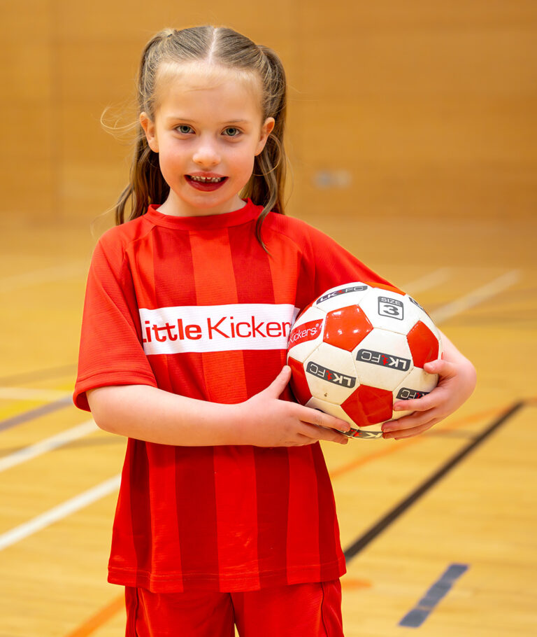 a child holding a football